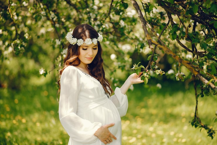 beautiful-young-pregnant-girl-long-white-dress-wreath-her-head_1157-13880
